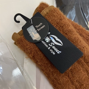 Detail view of brown faux mink touch screen knit gloves with branded M Sweet tag