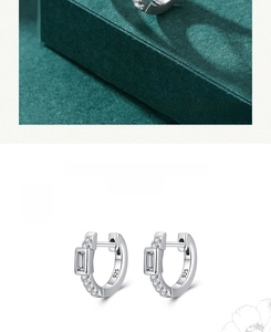 Macro shot of 925 sterling silver hoop earrings with rectangular baguette cut stones