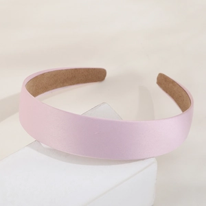 Pink satin wide headband with non-slip lining on white geometric stand for girls