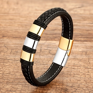 Detail of woven black leather bracelet with silver and gold magnetic stainless steel clasp