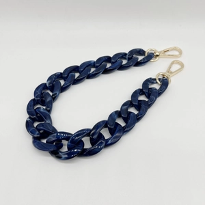 Close-up of dark blue marble acrylic handbag chain strap with gold metal lobster clasps