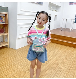 Detail of cute cat ear mini backpack with colorful sequins and transparent texture