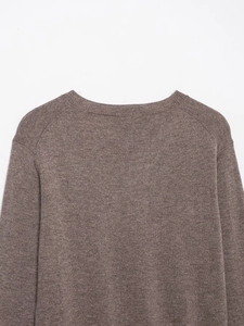Detailed view of brown wool blend knit sweater featuring raglan sleeves and crew neck collar