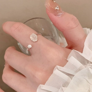 Silver adjustable open ring with oval resin gemstone and star detail on model hand