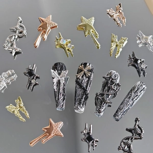 Black punk nail art set with silver metallic stars, butterflies and cross charms
