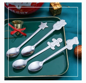 Detailed view of silver stainless steel Christmas spoons with 3D holiday character tops