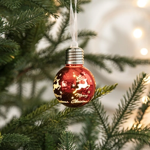 Bulb-shaped Christmas ornament with reindeer pattern hanging on a festive tree