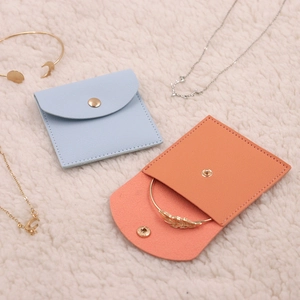 Mini microfiber jewelry organizer pouch with gold snap button in blue and pink