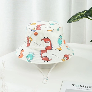 White kids bucket hat with colorful dinosaur prints and adjustable chin strap