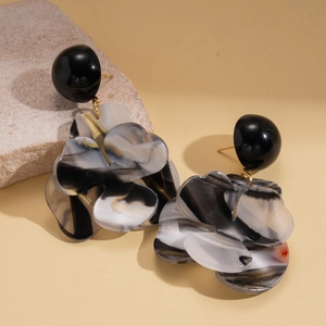 Chic marble resin flower drop earrings with golden accents on a natural stone base