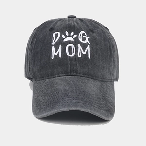 Detailed embroidery of DOG MOM text and paw print on washed cotton baseball cap