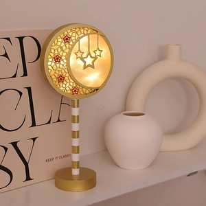 Golden moon and stars LED decorative night light with warm glow on a display shelf
