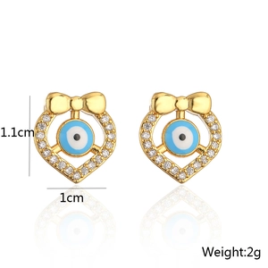 Detailed view of evil eye bow earrings in 18K gold plated copper with 1.1cm x 1cm dimensions