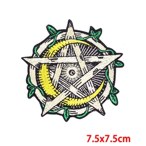 Close-up of star and yellow crescent moon embroidered patch with green vine details