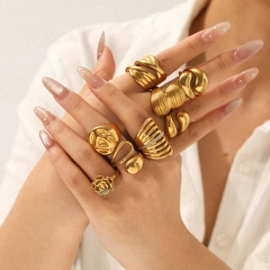 Detail of 18k gold plated stainless steel rings featuring rose and shell textures