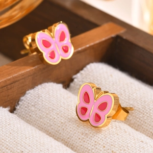 Macro detail of pink and red enamel butterfly stud earrings with golden finish