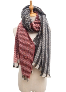 Detailed close-up of a warm red and grey striped scarf with decorative fringe edge