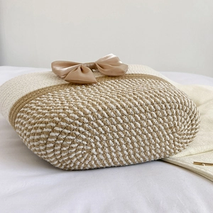 Handwoven straw tote bag with large champagne bow detail and cream brown color blocking