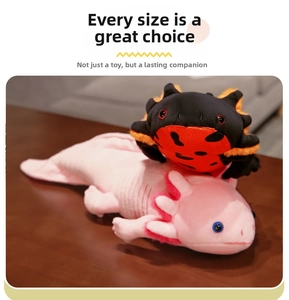 Pink axolotl plush toy with small spider doll on top, showing detailed fabric texture