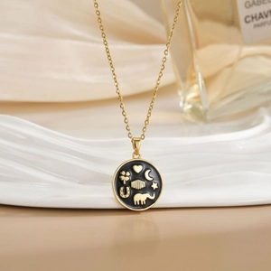 Gold-plated necklace with moon and elephant round pendant on elegant white display