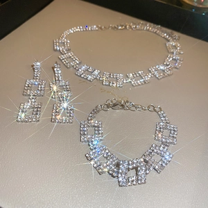 Detailed view of silver square jewelry set featuring luxury rhinestones on necklace and earrings