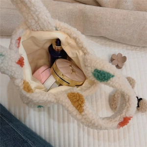 Detailed top view of plush polka dot tote bag showing interior storage for cosmetics