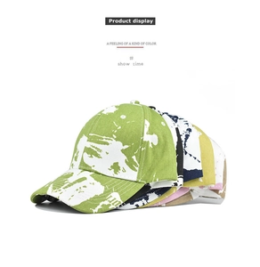 Multi-color tie-dye baseball caps collection with white paint splatter effect on cotton fabric