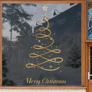 Golden spiral Christmas tree window decal with Merry Christmas text on a dark glass surface