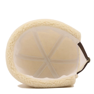 Detail of cream sherpa docker hat showing interior lining and adjustable leather strap
