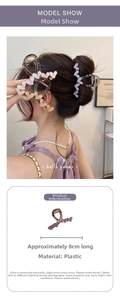 Detail view of 8cm acrylic heart hair claw clip with model showing wear and size