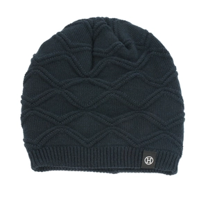 Close-up of navy blue knit beanie showing diamond texture and white H logo label