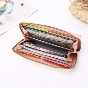 Pink quilted leather long wallet with zipper closure and spacious interior compartments