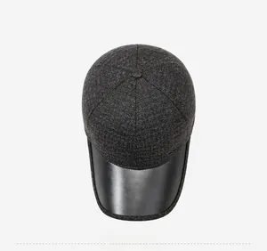 Top view of winter baseball cap showing dark grey wool knit and black leather brim