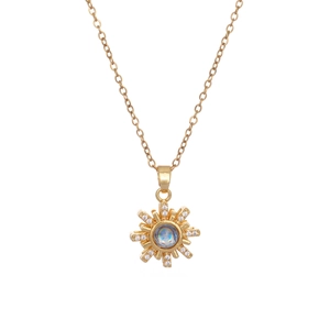 Golden sunburst necklace with central neon blue stone and zirconia accents on white background
