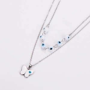 Detail of double-layer necklace with blue evil eye beads and silver butterfly pendant