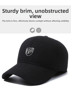 Close-up of a black winter baseball cap featuring a shield metal badge and thick wool fabric