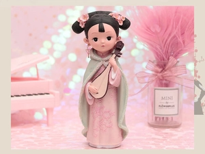Detailed view of Chinese style figurine holding a pipa with intricate hanfu relief