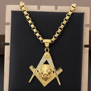 Macro shot of hip hop gold lion head pendant with freemasonry logo and clear crystals
