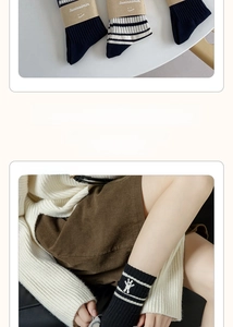 Close-up of navy blue and striped cotton socks with cute rabbit embroidery detail
