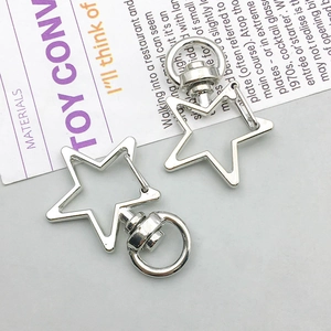 Detail of two star-shaped silver metal lobster clasps for DIY keychain making