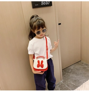 Girl wearing the cute bow and rabbit ear shoulder bag with a stylish casual outfit