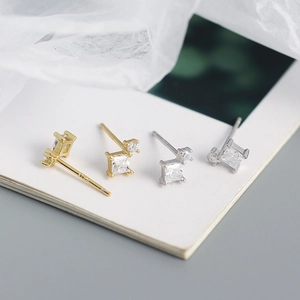 Macro shot of geometric square zircon studs in gold and silver s925 sterling silver