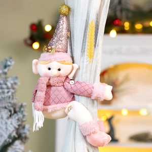 Pink Christmas elf curtain tieback with sequin hat shown on a curtain with warm lights