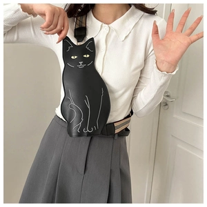 Detail of cute black cat crossbody bag with white embroidery and plaid shoulder strap