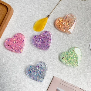 Glitter heart-shaped expandable phone sockets in multiple colors for desk support