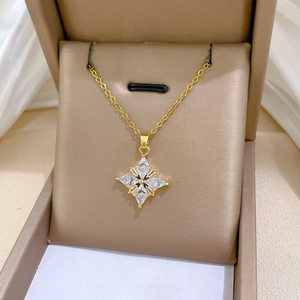Macro shot of gold four-pointed star necklace with sparkling cubic zirconia in jewelry box
