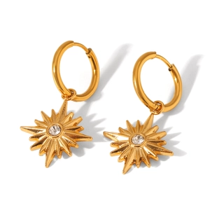 Detail of 18K gold-plated star earrings with sparkling central zircon stone setting