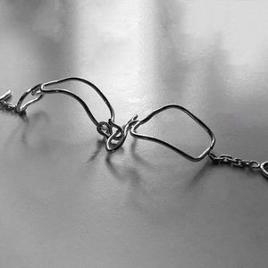 Minimalist 925 sterling silver knotted braided bracelet with polished metallic finish