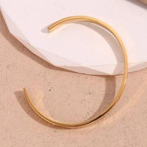Detailed macro view of 18K gold plated bangle featuring sparkling zircon star embellishments