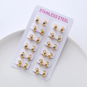 Set of 12 pairs of minimalist golden stainless steel hoop earrings on a display card